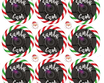 Könnte beinhalten: Neun rot-grüne Kreise mit Zuckerstangenstreifen, einer schwarzen Kamera-Linse und dem Text "Santa Cam" in Weiß.