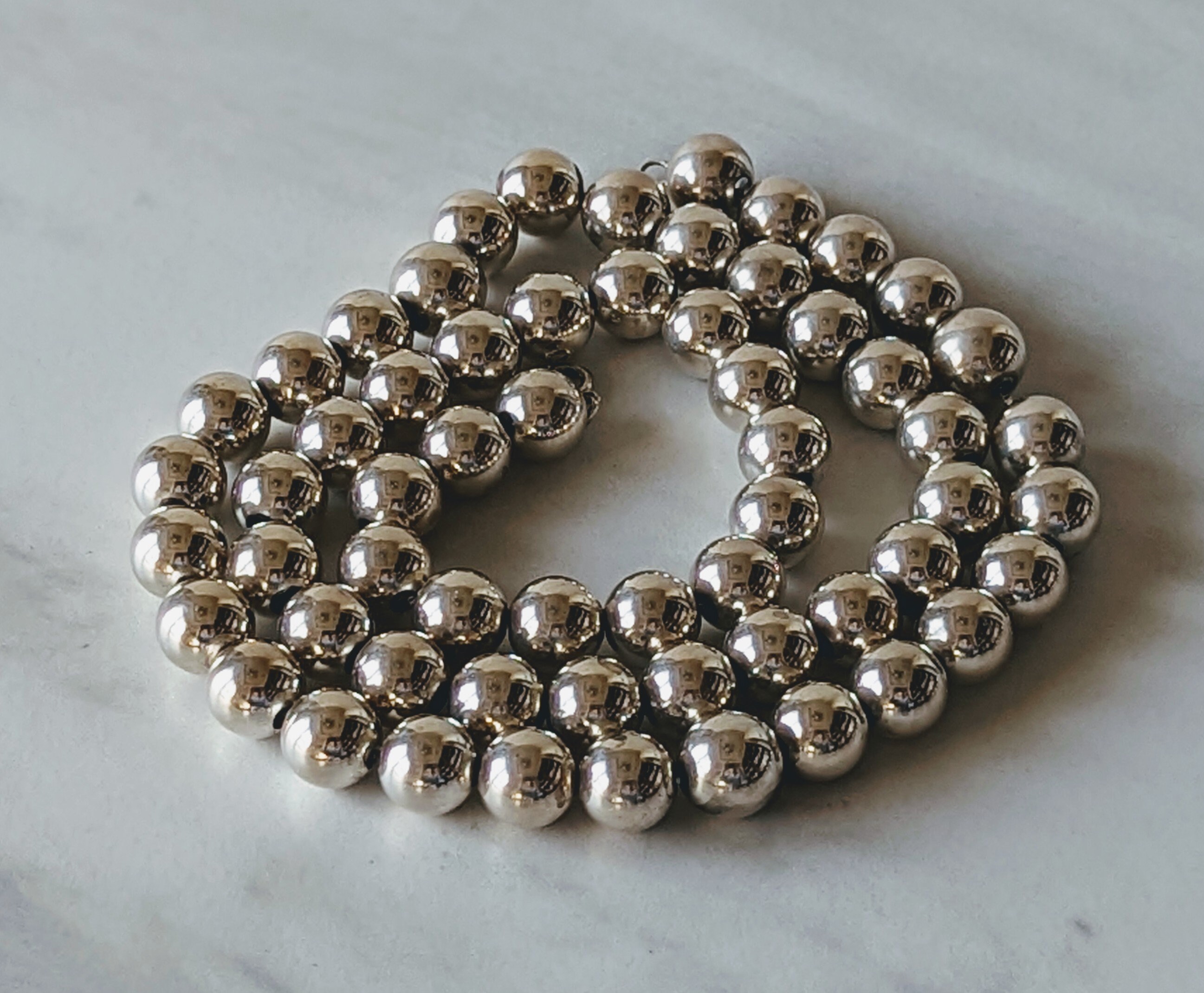 Add a cheap bead necklace 80s