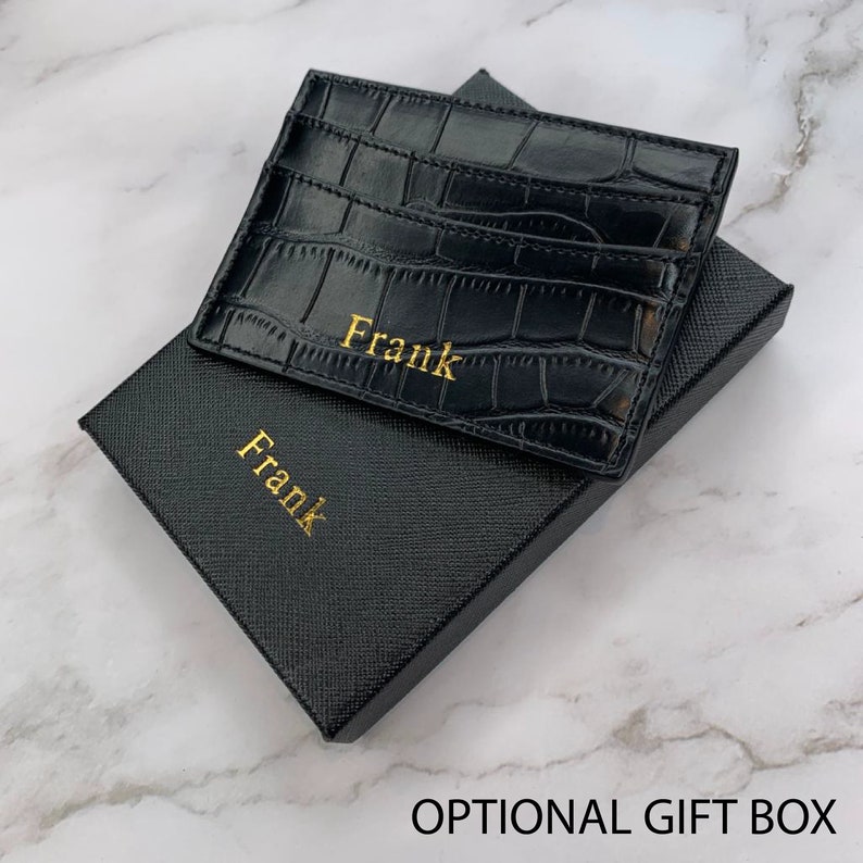 black alligator vegan leather card holder with gold embossed name on lower part of product on top of optional gift box with embossed name on lower part of the box