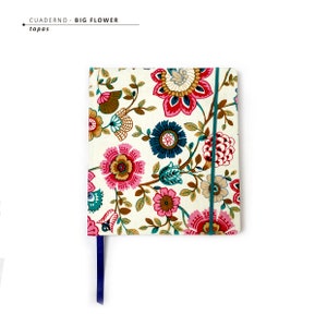 May include: A white notebook with a floral pattern in shades of pink, red, blue, and green. The notebook has a blue ribbon bookmark and the text "CUADERNO - BIG FLOWER" and "tapas" on the front cover.