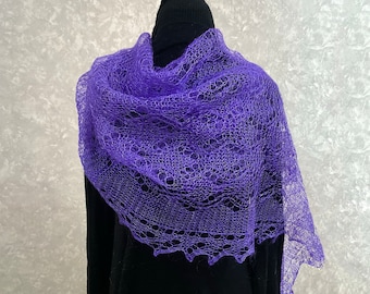 May include: A purple lace shawl with a delicate pattern. The shawl is draped over a black mannequin.