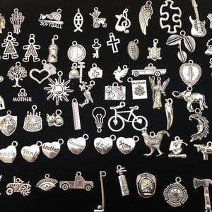 Lot of 100 Assorted New Age Silver Tone Milagros Charms,for altars, jewelry, mixed media art, and much more.