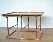 Handmade by 39 DISTINCTA 39 . Solid granite coffee side table with a copper tube base.