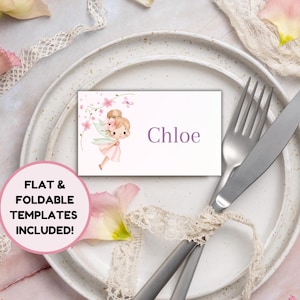 Puede incluir: Una mesa puesta con un plato blanco, cubiertos y una tarjeta con el nombre. La tarjeta con el nombre presenta una ilustración de hadas y el nombre "Chloe". Flores rosas y cintas de encaje decoran la mesa. El texto de la imagen dice "FLAT & FOLDABLE TEMPLATES INCLUDED!"