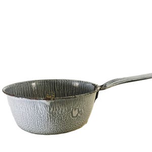 May include: A round enamel saucepan featuring a gray and white mottled pattern across the exterior and interior surfaces. The cookware has a single elongated handle extending from the side and a small pouring spout on the rim of the basin.