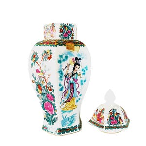 May include: A white ceramic vase with a matching lid, featuring a hand-painted design of a woman in traditional attire, flowers, and birds. The vase has a rectangular shape with a wide base and a decorative top.