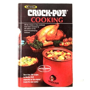 May include: A vintage cookbook titled "Crock-Pot Cooking" by Marilyn Neill. The cover features a roasted chicken, vegetables, and a red Crock-Pot. The book is published by Rival and has been reviewed by the Good Housekeeping Institute.