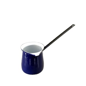 May include: A cobalt blue enamel coffee pot with a long, black handle. The pot has a white interior and a white rim. The handle is attached to the side of the pot and extends outward. The pot is designed for stovetop use.