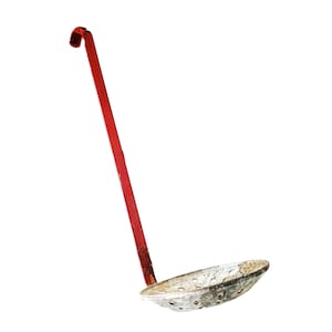 May include: A vintage metal skimmer with a long, red handle and a perforated bowl. The skimmer is designed for removing food from liquids. The handle is approximately 30 cm long, and the bowl is about 10 cm in diameter.