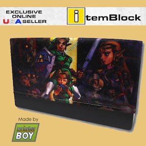 May include: A black wallet with a colorful print of characters from the Legend of Zelda video game series. The print features Link, Zelda, and other characters from the game. The wallet has a black zipper and a black strap. The text "Made by printer BOY" is printed on the bottom of the wallet.