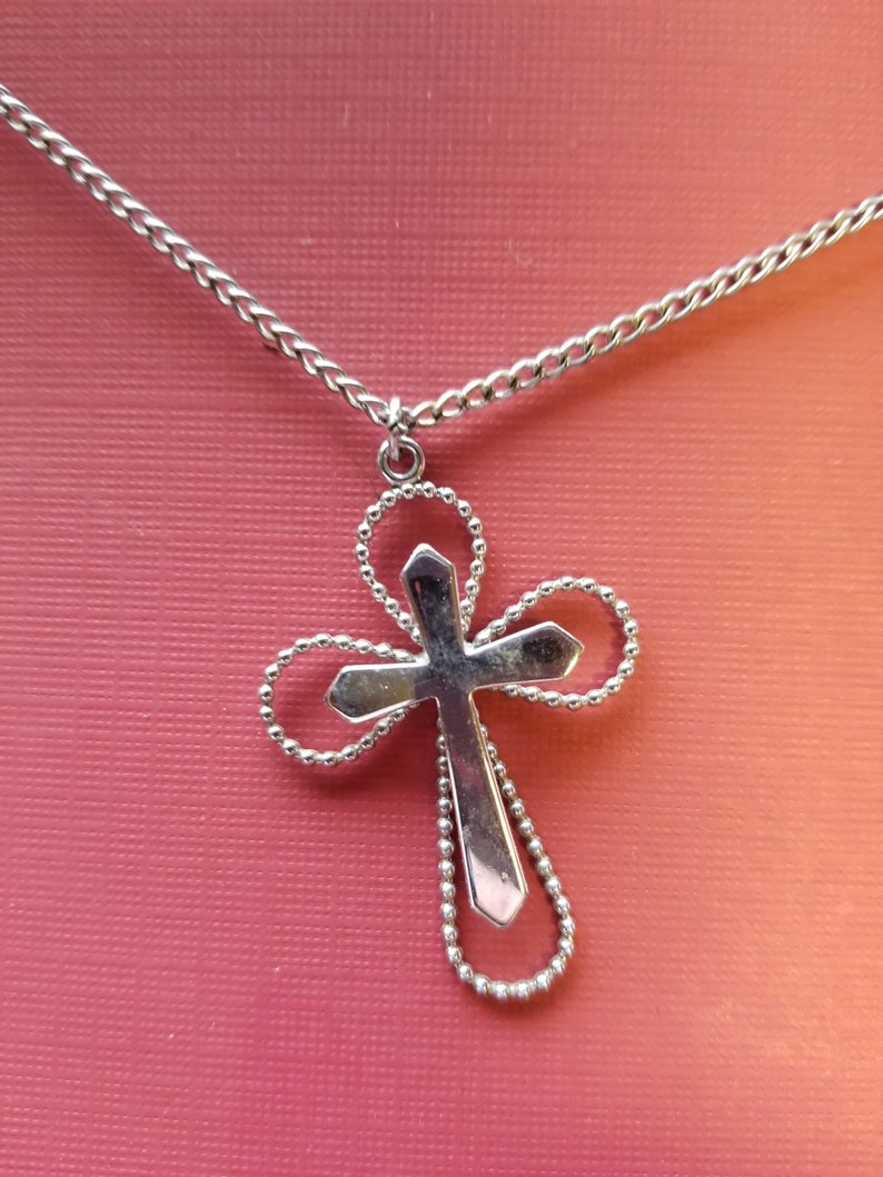 Necklace Sarah Coventry silver color curb chain holding a simple but elegant cross