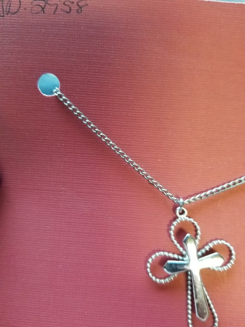 Necklace Sarah Coventry silver color curb chain holding a simple but elegant cross