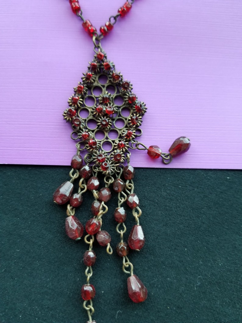 bronze wire with red beads with design charm in bronze and red beads Necklace
