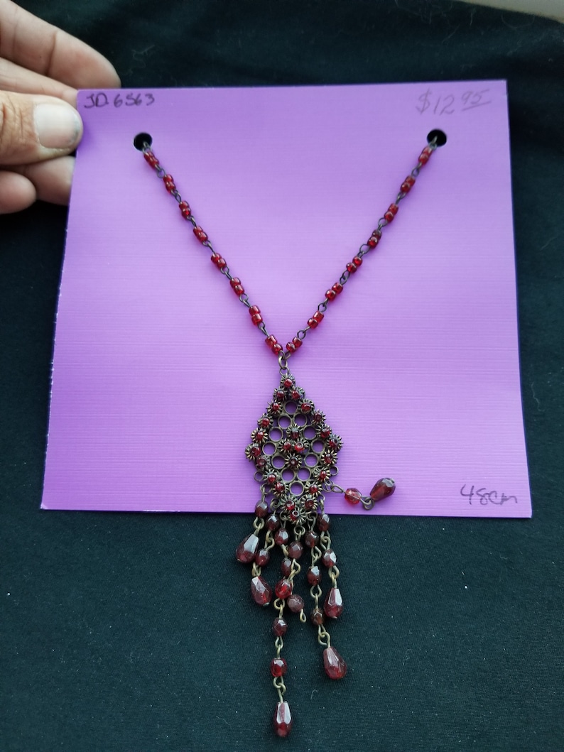 bronze wire with red beads with design charm in bronze and red beads Necklace