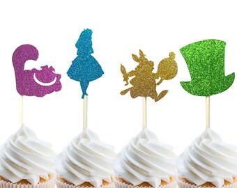May include: Four cupcake toppers featuring characters from Alice in Wonderland. The toppers are made of glitter cardstock and feature a purple Cheshire Cat, a blue Alice, a gold Mad Hatter, and a green top hat.