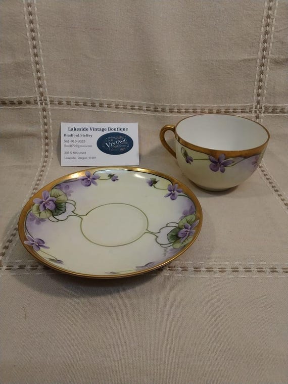 Vintage German teacup and saucer set, signed by maker.