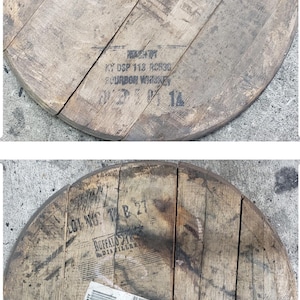 May include: Two wooden barrel heads with markings from Buffalo Trace Distillery. The top head has the text "Buffalo Trace Distillery" and "KY DSP 113 K0530 BOURBON WHISKEY 01 21 14". The bottom head has the text "Buffalo Trace Distillery" and "UT MASH KY DSP 113 K0530 BOURBON WHISKEY ALLE 02 14".