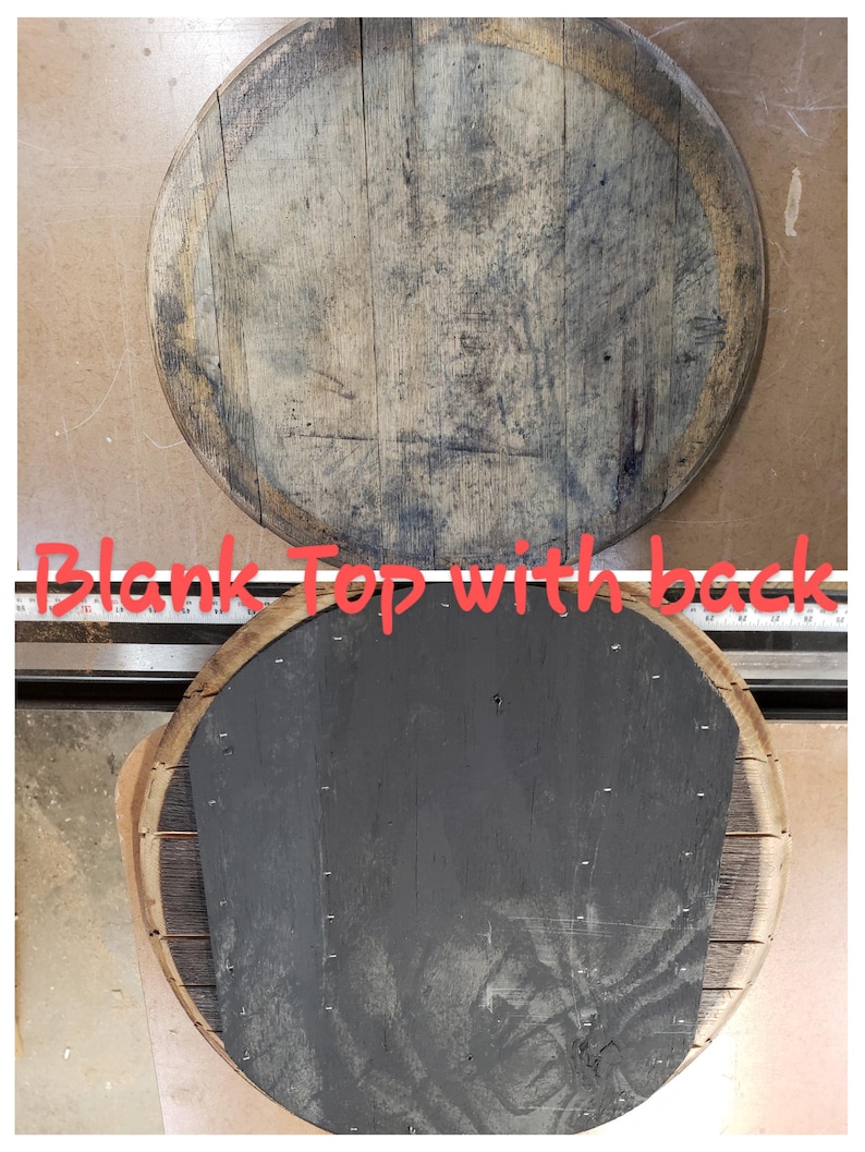May include: A round wooden top with a natural wood finish. The top is blank and ready to be decorated. The back of the top is painted black.