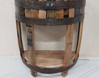 May include: A half-barrel table made from reclaimed wood with a metal frame and a shelf. The table is brown and has a rustic look.
