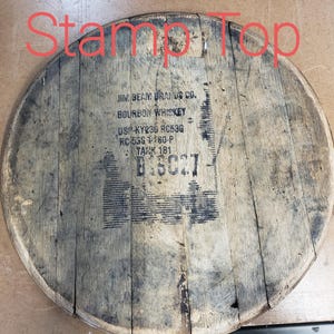 May include: A wooden barrel top with the text "JIM BEAM BRANDS CO. BOURBON WHISKEY DS-KY236 RC53G RC-535 1180-P TANK 181" printed on it.