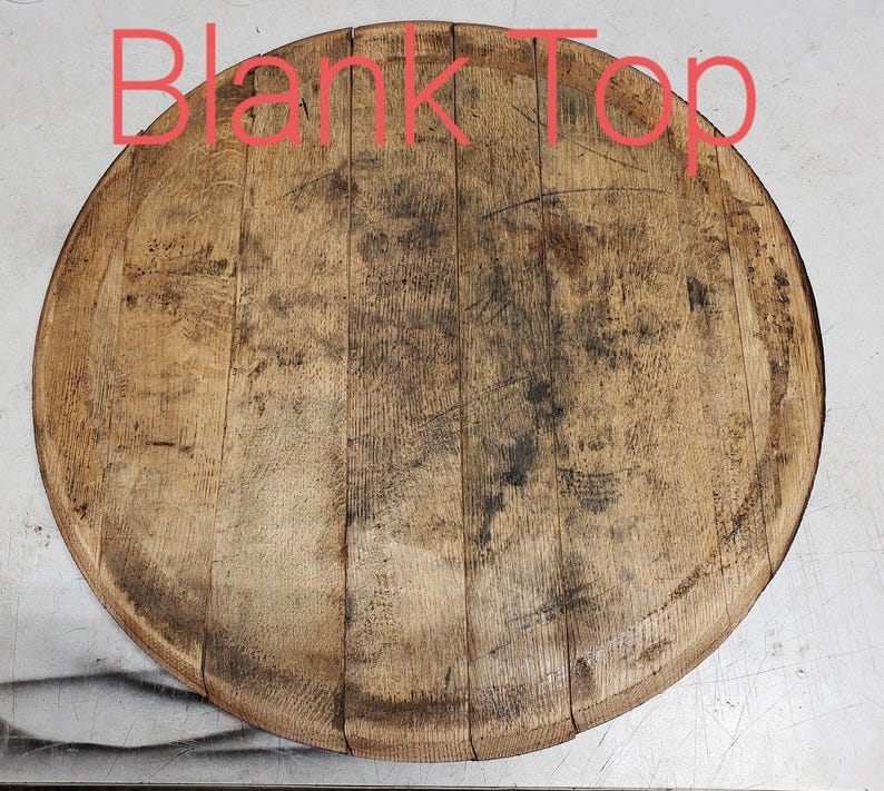 May include: A round wooden top, likely from a barrel, with a natural wood finish and visible grain. The top is slightly weathered and has a few dark spots.