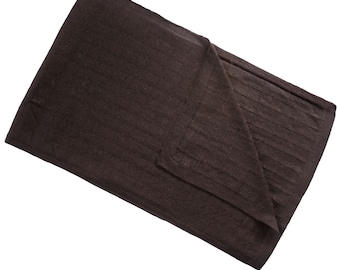 May include: A folded, dark brown scarf. One section has a ribbed texture. The scarf is made of a soft material and is folded neatly, showing its shape and design. The overall look is simple and elegant.