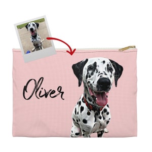 May include: Pink zippered pouch with a black and white Dalmatian dog illustration and the name "Oliver" written in black cursive.