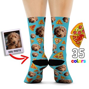 May include: A pair of blue socks with a pattern of pizza slices and a dog's face. The socks are shown on a model's feet. The image also includes a photo of the dog and a text overlay that says "DOG PHOTO" and "35 colors".