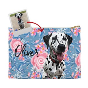 May include: A blue and pink floral print zipped pouch with a photo of a Dalmatian dog named Oliver on the front.