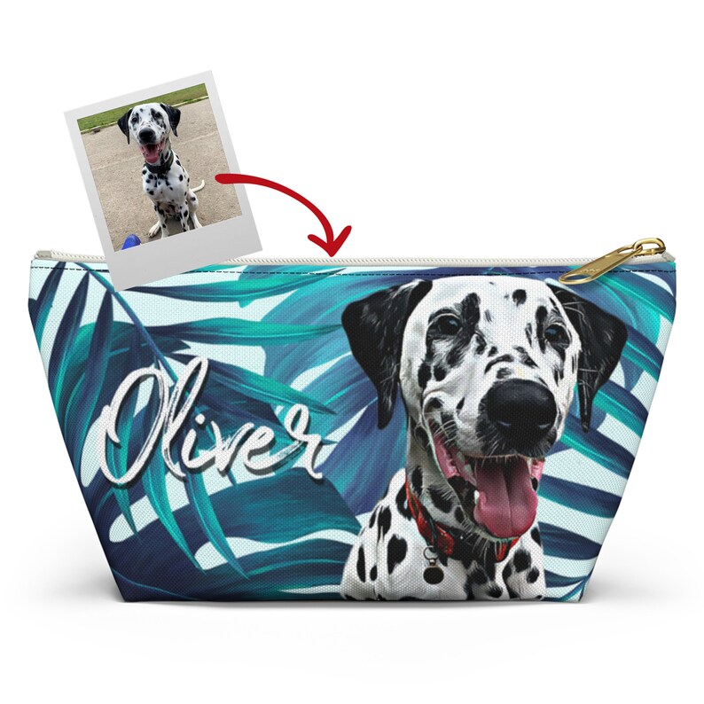 May include: A white and black Dalmatian dog with a red collar is featured on a blue and white tropical leaf print zippered pouch. The pouch has the name "Oliver" written in white cursive on the front.
