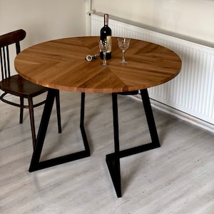 Solid oak round dining table. Scandinavian style table. Handmade, high-quality. Steel frame extending black table. Comfort line FJÄRIL BLACK