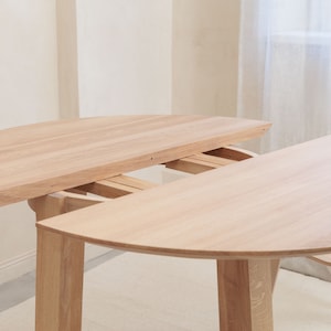 Round extendable oak dining table in Japanese style: ORBIS - Handcrafted, big eco-friendly modern wooden table. 100% wood quality.