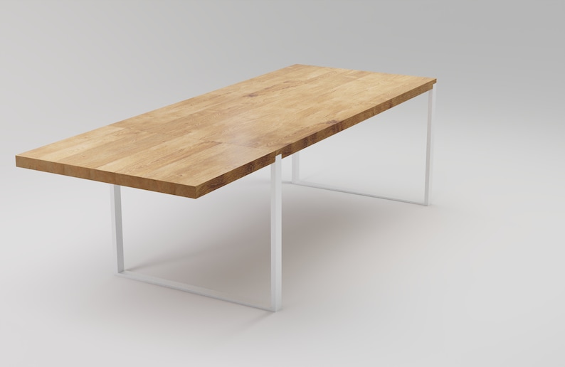 May include: A rectangular wooden table with a white metal frame. The table top is made of light wood with a natural grain pattern. The table is on a white background.