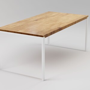 May include: A rectangular wooden table with a white metal frame. The table top is made of light brown wood with a natural grain pattern.