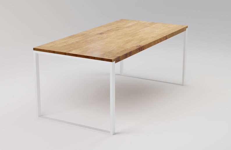 May include: A rectangular wooden table with a white metal frame. The table top is made of light brown wood with a natural grain pattern.