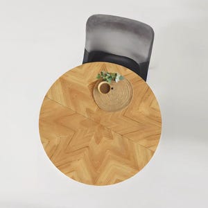 Round extendable table of solid wood FJÄRIL BLACK. Herringbone, chevron, starburst, standard pattern. Oak table for kitchen & dining room.