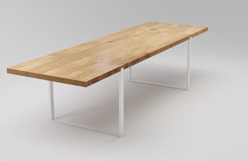 May include: A long, rectangular wooden table with a white metal frame. The table top is made of light wood with a natural grain pattern.
