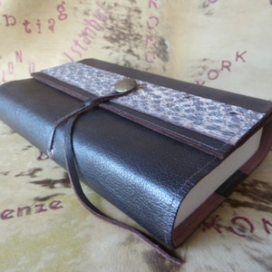 29 - Adjustable book cover in dark brown goatskin with printed leather band, for books up to 18 cm high