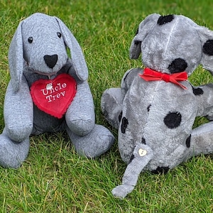 May include: Two grey plush dog toys. One is solid grey with a red heart that says "Uncle Trev". The other is grey with black spots and a red bow.