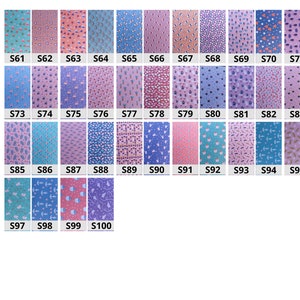 May include: A collection of 100 fabric squares, each with a different pattern. The squares are arranged in rows and columns, and each square is labeled with a number. The fabric squares are all 10 cm by 10 cm.