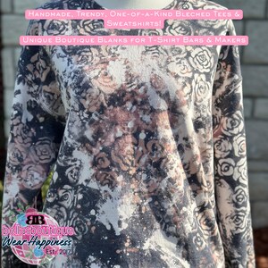 May include: A long-sleeved sweatshirt with a floral pattern in black, white, and brown tones. The shirt has a bleached effect with the text "HANDMADE, TRENDY, ONE-OF-A-KIND BLECHED TEES & SWEATSHIRTS!" and "UNIQUE BOUTIQUE BLANKS FOR T-SHIRT BARS & MAKERS".