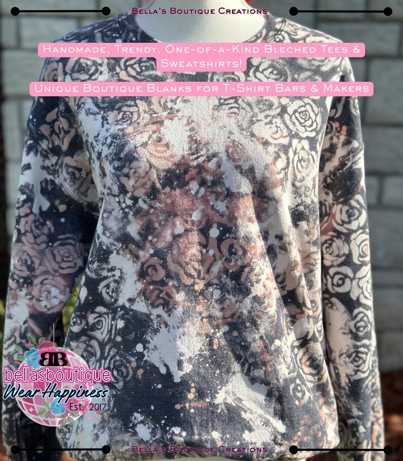 May include: A long-sleeved sweatshirt with a floral pattern in black, white, and brown tones. The shirt has a bleached effect with the text "HANDMADE, TRENDY, ONE-OF-A-KIND BLECHED TEES & SWEATSHIRTS!" and "UNIQUE BOUTIQUE BLANKS FOR T-SHIRT BARS & MAKERS".
