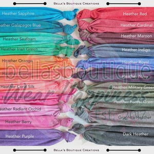 May include: A display of various colored fabric headbands, each knotted at the end. Colors include heather sapphire, red, orange, and purple. The text "Bella's Boutique Creations" is at the top and bottom of the image, with color names listed below each headband.