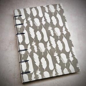 Cuaderno plumas blancas