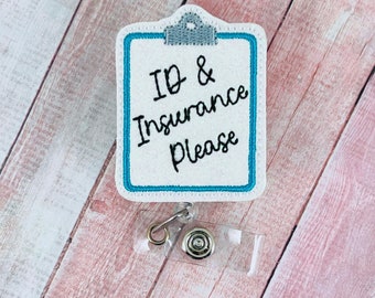 May include: White embroidered badge with a blue border, depicting a clipboard with the text "ID & Insurance Please". The badge is attached to a clear plastic retractable badge holder with a silver clip.