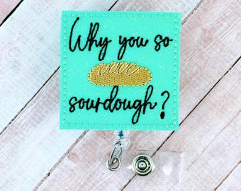 May include: A teal blue badge holder with the text "Why you so sourdough?" and a cartoon image of a loaf of bread.