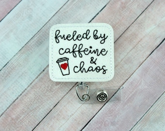 May include: White square badge holder with a black and white embroidered design that says "fueled by caffeine & chaos" with a red heart on a coffee cup graphic.