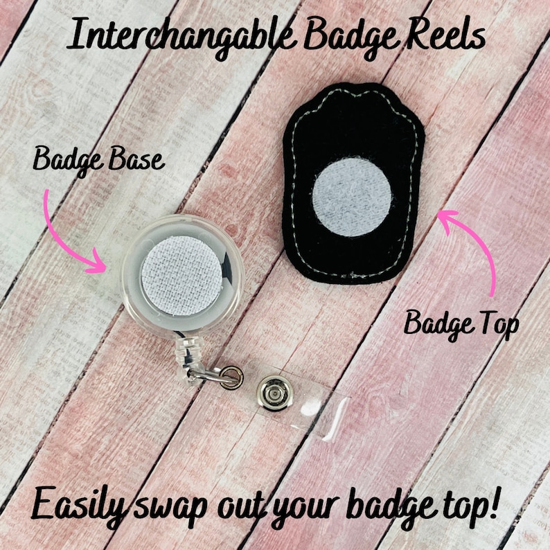 May include: Interchangeable Badge Reels. A clear badge reel with a white fabric circle in the center. A black badge top with a white fabric circle in the center. The text "Badge Base" is written above the badge reel and "Badge Top" is written above the badge top. The text "Easily swap out your badge top!" is written below the image.