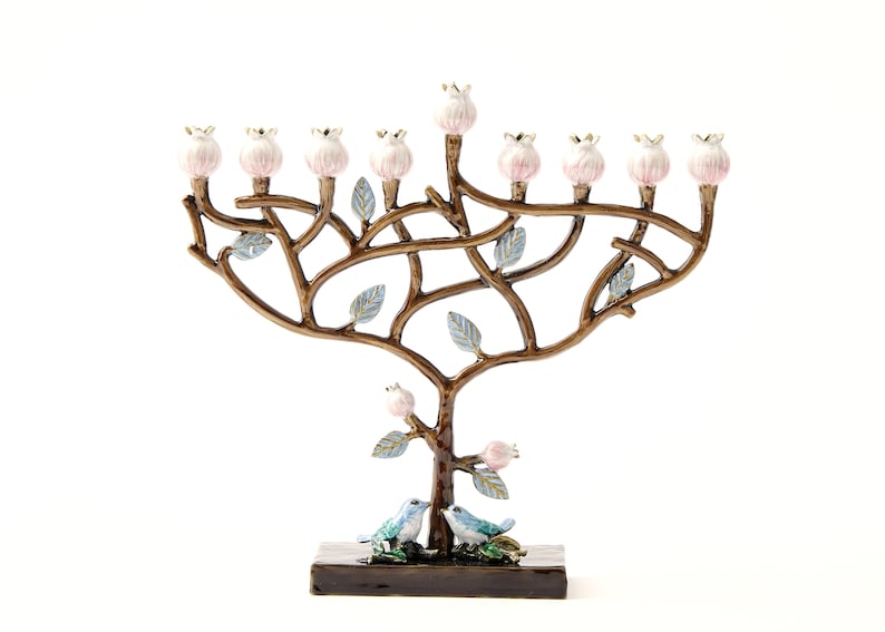 May include: A menorah shaped like a tree with pink flowers and blue birds. The menorah is made of metal and has a brown finish.