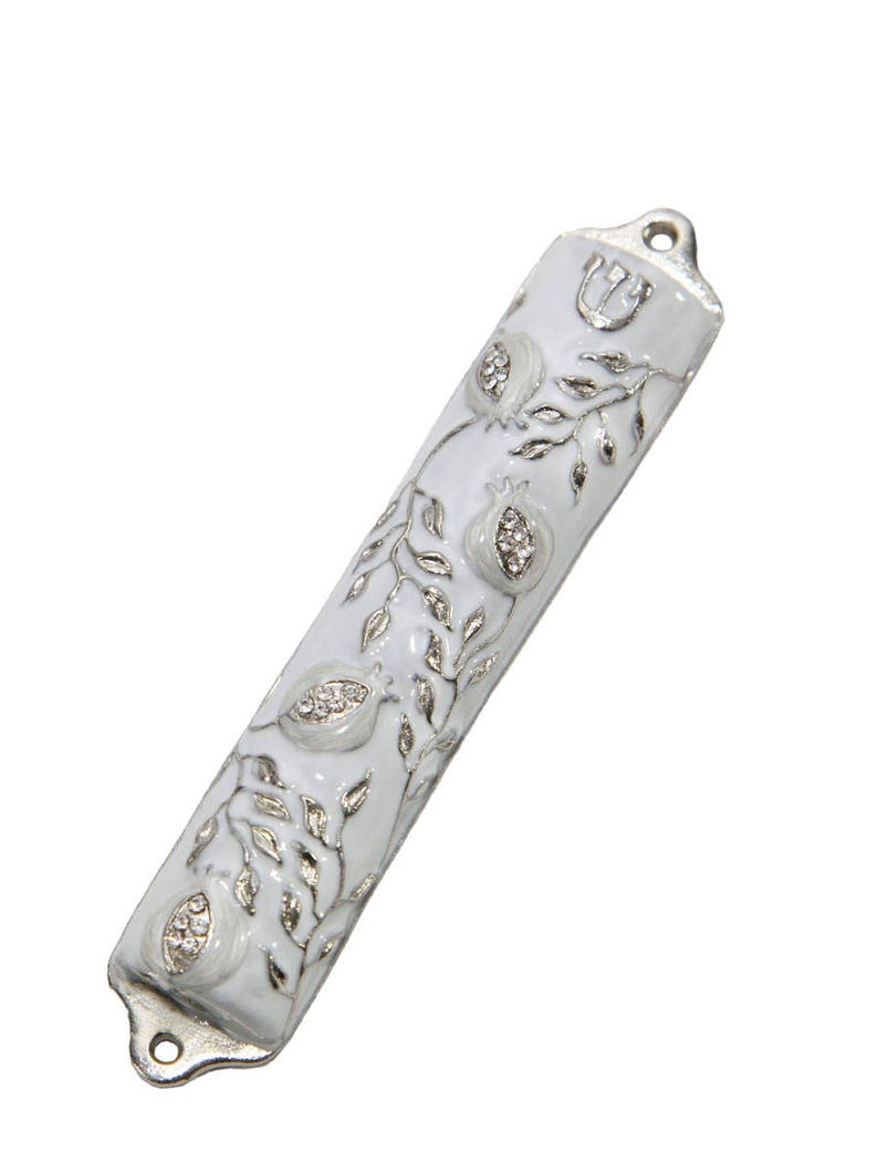 May include: White mezuzah with a silver design of pomegranates and a vine. The mezuzah has a silver Star of David at the top.